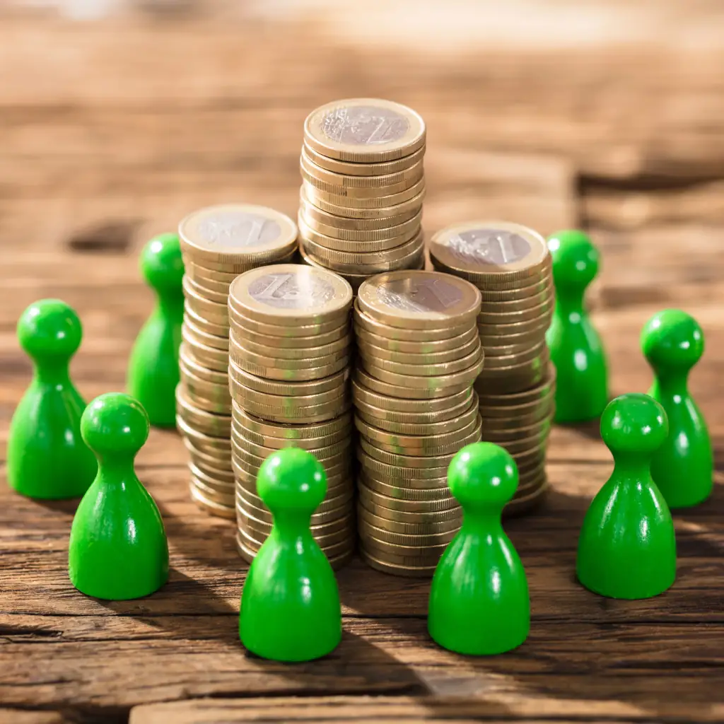 Small Plastic Green Pawn Pieces Circling Coins Stacked coins surrounded by green game pieces.
