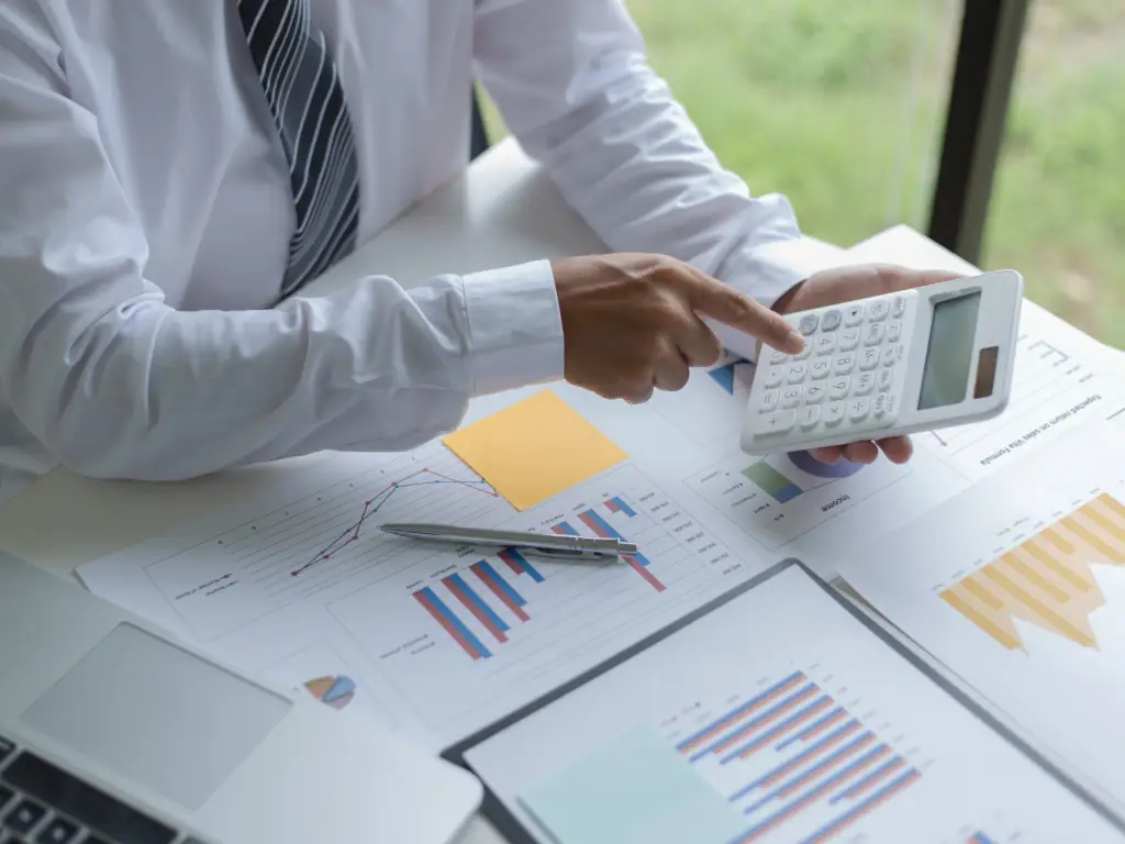 Business Person Checking Financial Reports Person using calculator on financial charts