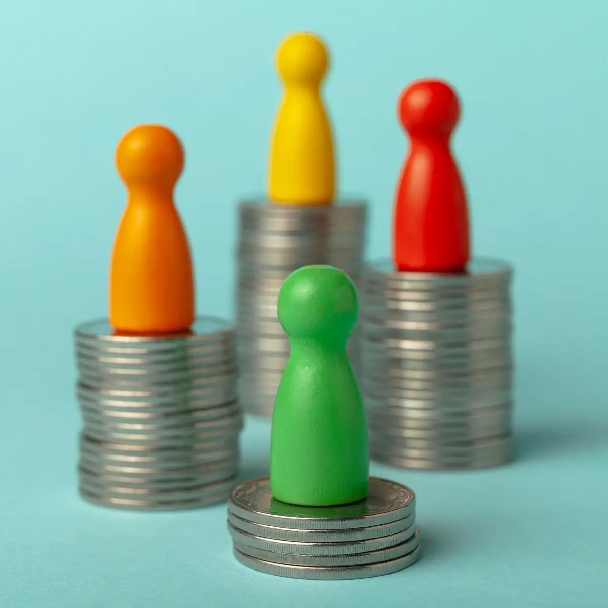 Game Pieces Coins Colorful game piece pawns on stacks of coins
