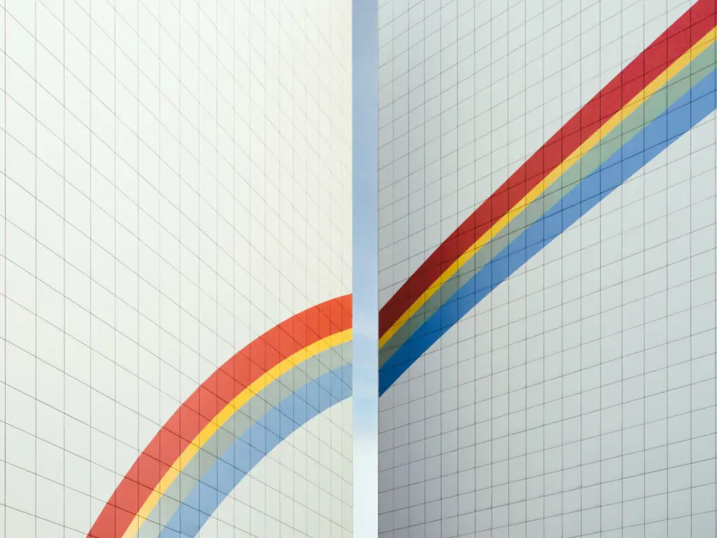 Colorful diagonal lines on white tiled wall